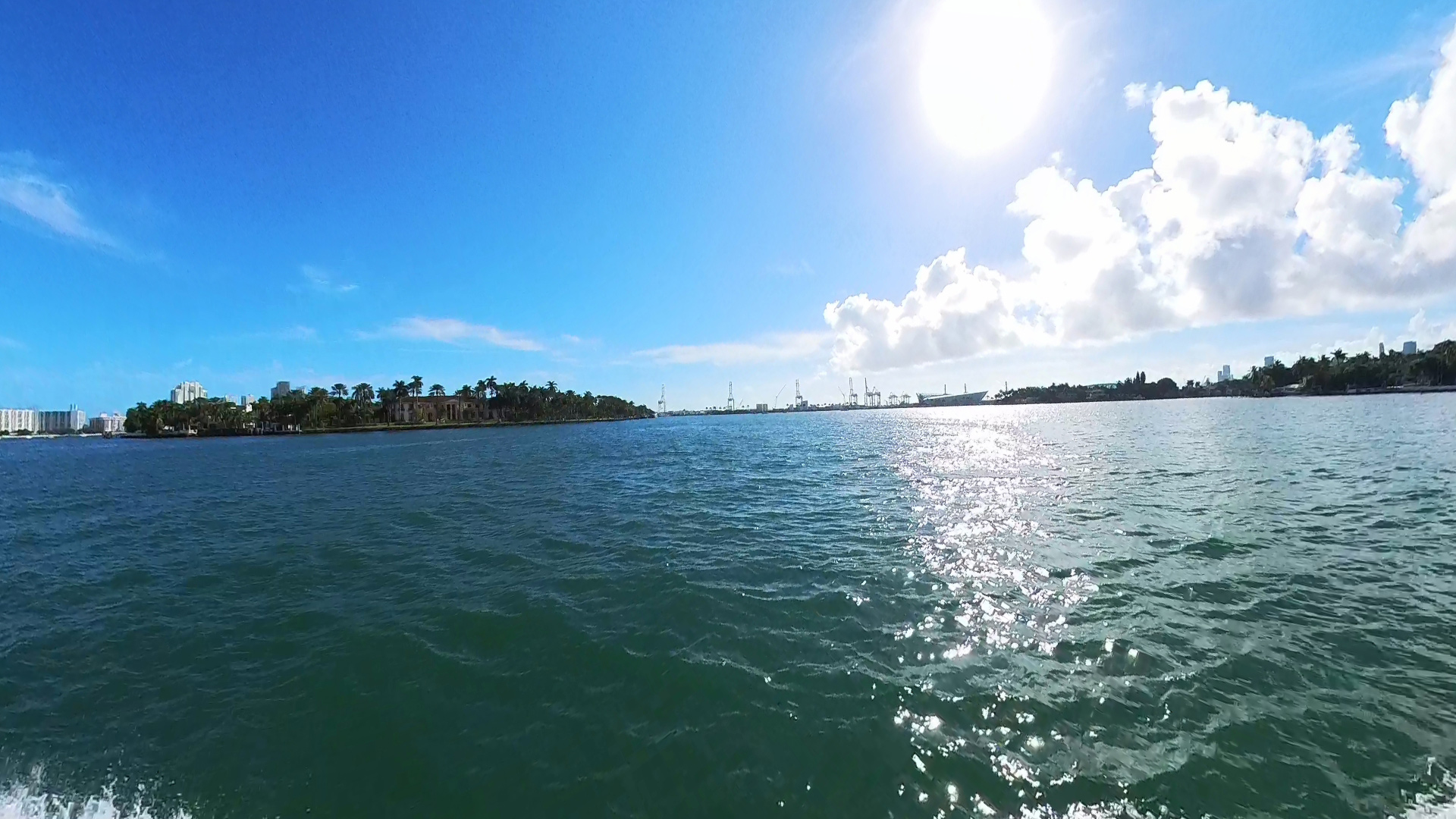 The sightseeing tour is cruise near Star Island with the Port of Miami in the background.