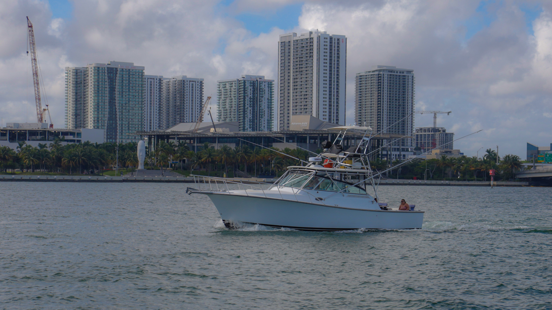 A fishing boat passes in front of the skyline.